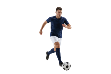 Male soccer player dribbling ball in studio on black background, athletic action and competitive sports concept for training, fitness promotion and team game advertising