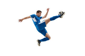 Male soccer player performing flying kick in midair on isolated black background, athletic action and competitive sports concept for training, fitness promotion and team spirit themes