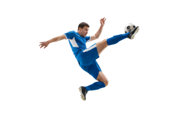 Male soccer player performing flying kick in midair on isolated black background, athletic action and competitive sports concept for training, fitness promotion and team spirit themes