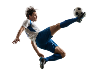Male soccer player performing airborne kick with ball isolated on black, dynamic sports action for competition, coaching and fitness training concepts
