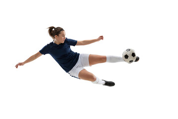 Female soccer player performing acrobatic volley kick in midair on isolated black background, athletic action and competitive sports concept for training, fitness motivation, and team promotion