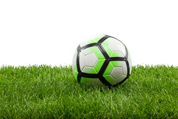 Soccer ball resting on green grass with copy space, close-up sports equipment concept for training, youth league and outdoor recreation on a clean white background