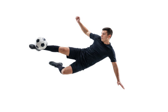 Male soccer player performing flying kick in mid air on isolated black background, athletic action and competitive sports concept for training, fitness promotion and team game energy