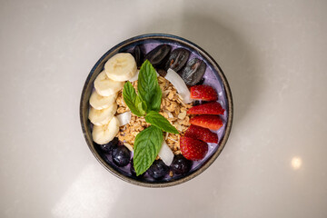 Healthy Delight: A vibrant bowl bursting with a rainbow of fresh fruits and granola, a nutritious and visually appealing breakfast or snack option.