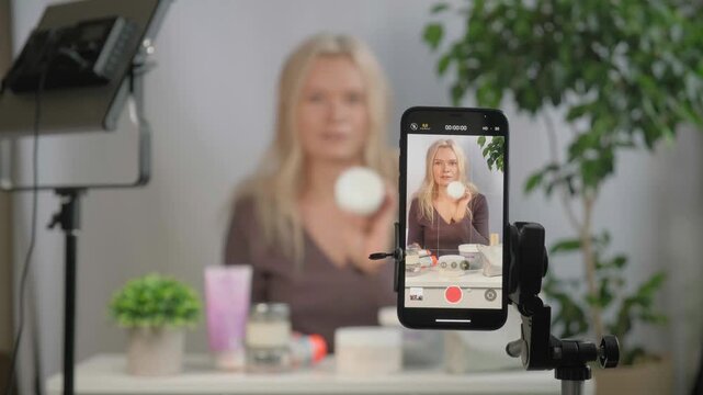 Face, makeup influencer or vlog with girl, spray or advice with content creator, promotion for cosmetics product or live streaming. Portrait, person or woman with item for skincare or record tutorial