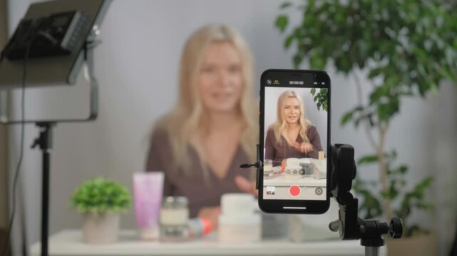 Face, beauty vlogger or influencer with girl, using spray or giving tips as content creator, promotion for skincare product or live streaming. Portrait, woman or person with item for makeup tutorial