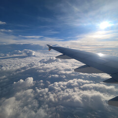 Airplane Wing Above Clouds at Sunrise