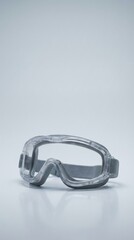 Clear safety goggles designed for protection during various activities, featuring a sleek design and comfortable fit, ideal for use in laboratories or workshops with copy space