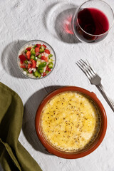 Provolone cheese baked in oven seasoned with oregano, argentinian provoleta.