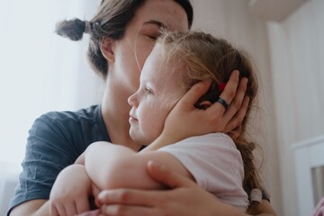A 4-year-old girl just woke up from nap, stretching in her sunny bedroom. Authentic childhood...