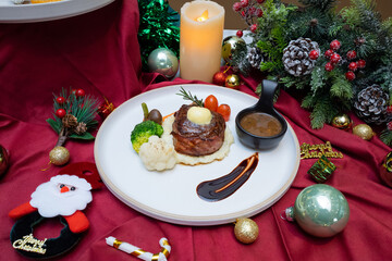 Christmas dinner. Delicious meal presentation with a candle in the background.