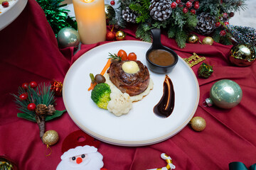 Festive gourmet steak dish beautifully presented on a plate, adorned with vibrant side dishes and festive decorations