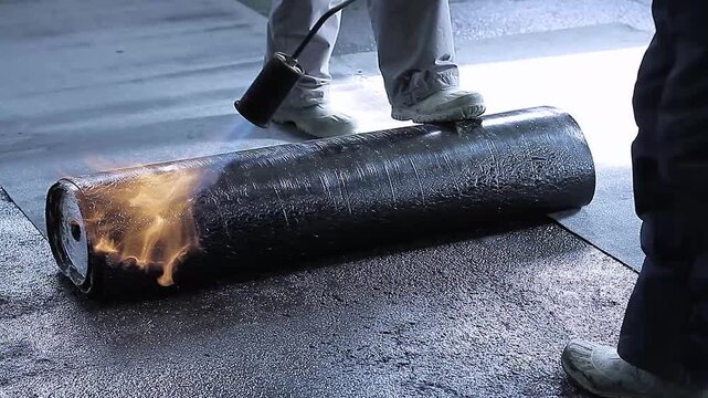 builders laying down waterproofing lino waterproofing floor area with people stock footage stock photo