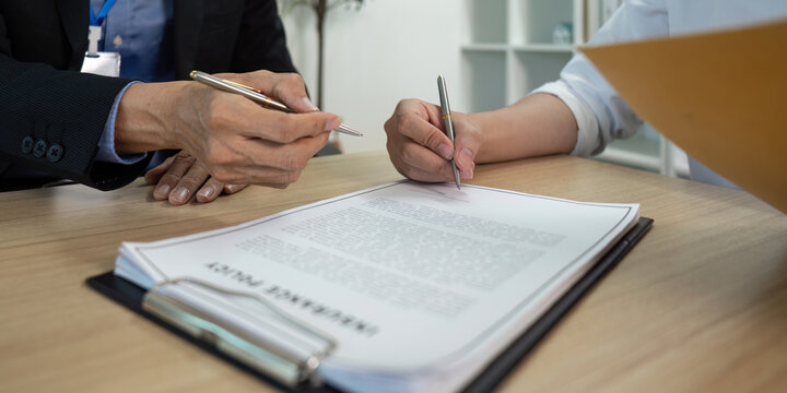 Contract Signing. Professionals reviewing and signing important business documents.