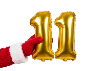 Hand in red winter glove holding gold number eleven balloons on white background, festive party decor for birthday anniversary and holiday countdown celebration
