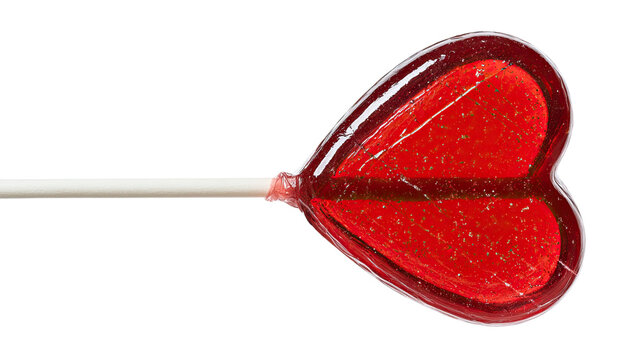 Red lollipop in heart shape on white or green background, an isolated sweet target for accuracy in a game of darts and a symbol of love