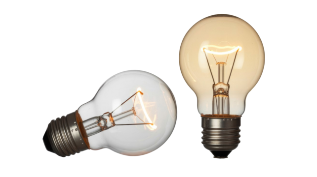 A clear unlit light bulb lies next to a glowing, lit incandescent bulb standing upright, both on a transparent background. background removed