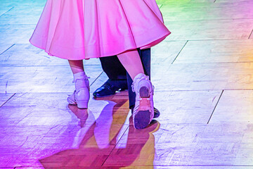 young pair of juvenile dancers on the dance floor during a dance.