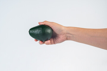 Avocado and hand isolated on white background close-up.