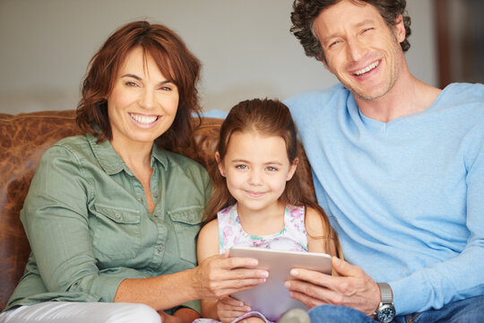 Learning, portrait and tablet with family on sofa in living room of home together for child development. App, education or gaming with mother, father and daughter in apartment for bonding or study