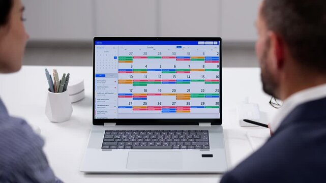 Online Calendar For Business Schedule. Two People Looking