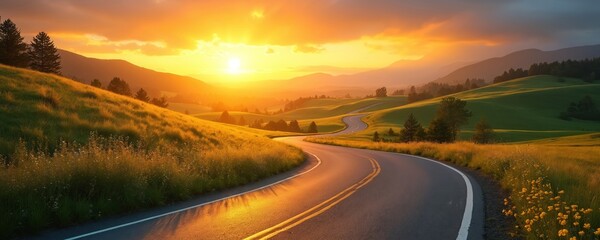 Golden sunrise light illuminates winding country road through rolling green hills, distant mountains. Scenic rural landscape shows journey path. Bright sun shines on empty asphalt way. New