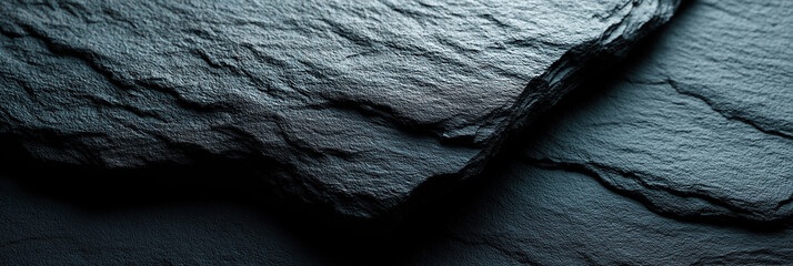 Layered slate stone surface features smooth teal-blue natural geological formations.