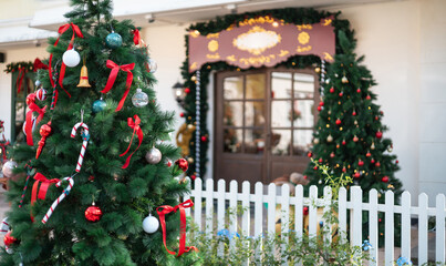 close-up view, christmas tree with item christmas. white fence with christmas decorate at a door in winter, celebrate in christmas holiday