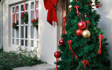 close-up view, christmas tree with item to decorate and window have christmas wreath hanging on, celebrate in christmas holiday