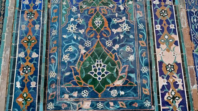 Close view of detailed blue tilework and calligraphic ornamentation on the Ulugh Beg Madrasa in Samarkand, Uzbekistan.