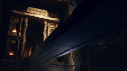 Fototapeta premium An enchanting underground chamber reveals intricately carved ancient columns, illuminated by flickering lights casting ethereal shadows. A sense of mystery fills the ancient space.