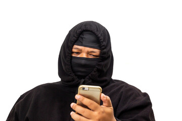 Suspicious Person Hidden in Dark Clothing Using a Smartphone with Secret Intentions Isolated