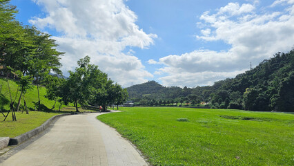 Taipei City, Taiwan. November 15, 2025. Scenic riverside riding U-Bike cycling path in Xindian with open green landscape and clear sky creating a relaxing eco-friendly outdoor atmosphere