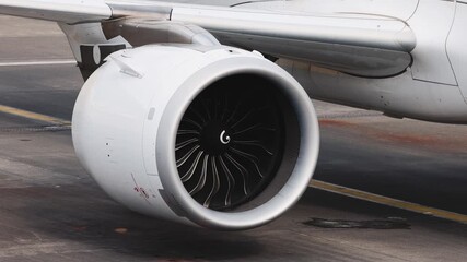 Aircraft engine close-up showcasing intricate turbine design and smooth aerodynamic curves, emphasizing engineering excellence and precision, camera zooms in for detail