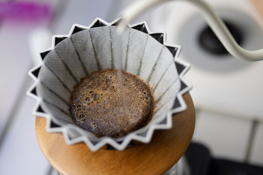 Barista pouring hot water on coffee ground with filter , Hand drip coffee