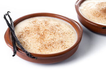 Creamy homemade Spanish custard served in a bowl with cinnamon isolated on white background