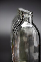 Empty glass bottles in a row on black background
