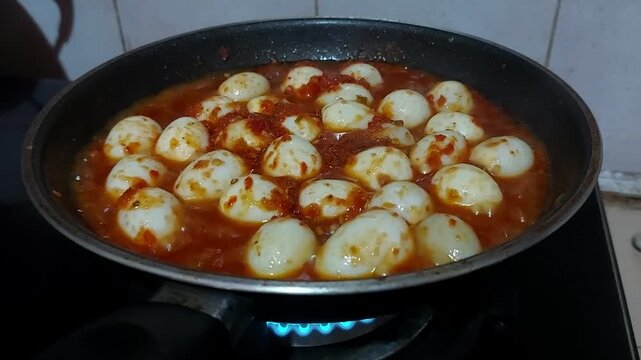 Boiled Quail Eggs Pepper Sauce spicy flavored contains lots of chili, egg balado Indonesian food. Perfect for recipe, article, or any cooking contents.