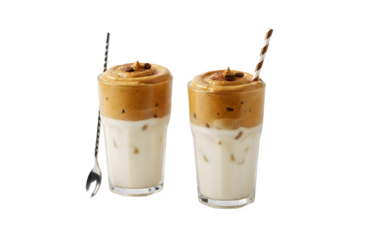 Cups of tasty dalgona coffee set against a white background
