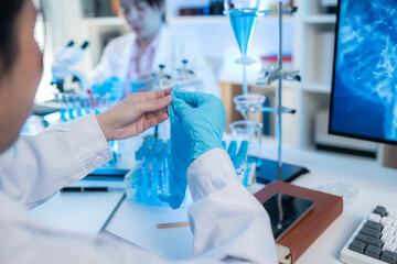 A modern scientific laboratory interior with organized glassware, test tubes filled with blue...