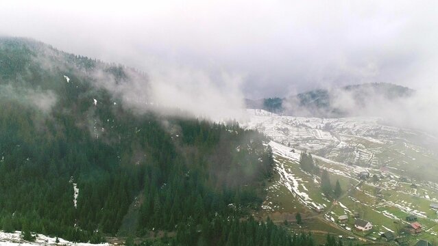 Clouds above green mountain fields with snow and grass - Powered by Adobe