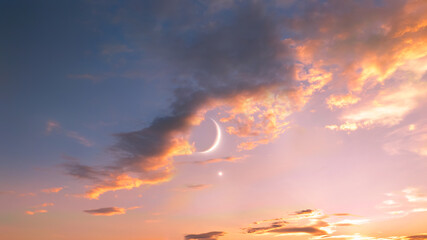 New moon with Venus at sunset. Moon and planet in the sky between clouds. Celestial landscape.