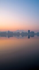 City skyline reflected in water at sunrise with a beautiful gradient sky above it all