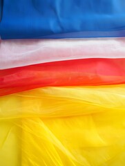 Colorful fabric layers of blue white red and yellow texture with soft lighting effect