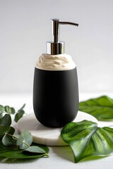 Elegant black and white soap dispenser with green leaves decoration around it