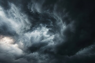 Obraz premium Dramatic Storm Clouds - Swirling Dark Sky with Intense Light and Texture.