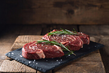 Fresh raw pork chops on a wooden cutting board