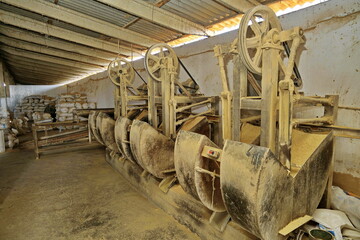 Industrial rice dehusking machines in grain processing plant, sacks and dust from active milling