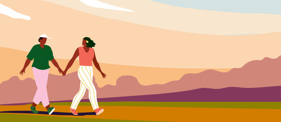 Two Women Walking Outdoors hand in hand in a warm colors landscape with sunset sky and distant hills