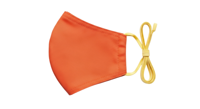 Isolated bright orange face mask with yellow elastic adjustable straps in studio shot